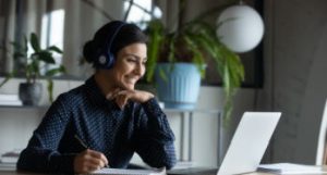 Young woman looking at laptop and smiling